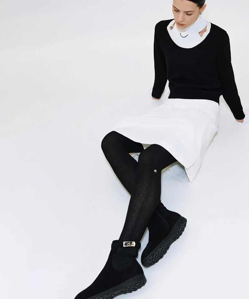 Golf tights layered under a pleated golf skirt for cold weather